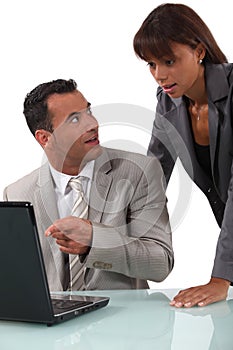 Shocked colleagues reading an e-mail