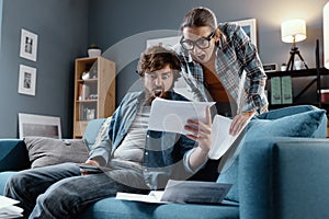 Shocked couple checking their household bills