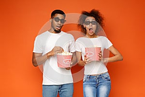 Shocked couple 3d glasses watching movie with popcorn