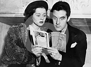 Shocked couple reading together
