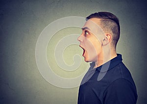 Shocked dazed man isolated on gray background