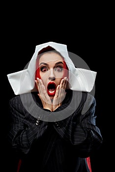 Shocked demonic nun with red eyes and open mouth isolated