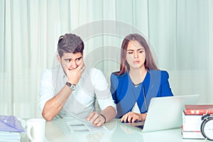 Shocked expressive man and woman watching laptop