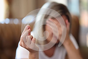 Shocked female holding wedding ring in hand