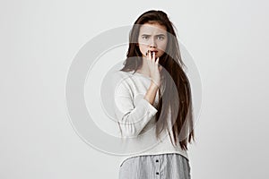 Shocked female in loose shirt with surprised expression, finds out unexpected news, can t believe in words she is told