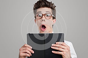 Shocked funny student with book