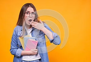 Shocked funny student with books in glasses