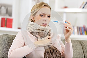 shocked girl holding white thermometer