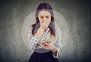 Shocked girl reading a message a smartphone