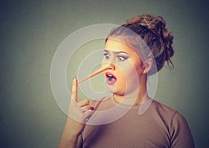 Shocked liar woman with long nose photo