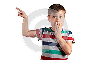 Shocked little boy pointing with his finger on something, isolated on white background