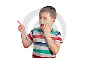 Shocked little boy pointing with his finger on something, isolated on white background