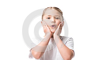 shocked little girl with hands on face looking at camera