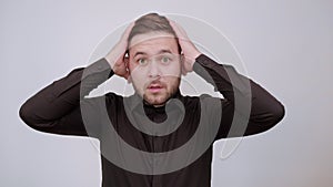 Shocked Male Holds Hands Over His Head And Emotionally Made Big Eyes