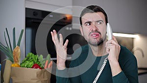 Shocked man getting unexpected news on the phone