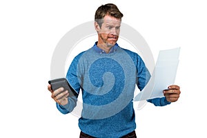 Shocked man holding calculator and paper