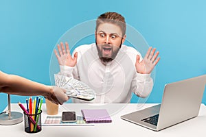 Shocked man office worker with beard raising hands and screaming looking at hands with big sum of hundred dollar bills, receiving