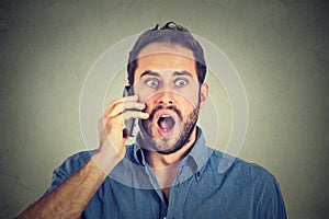 Shocked man talking on mobile phone