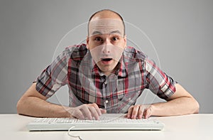 Shocked man using keyboard
