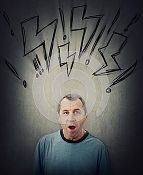 Shocked middle aged man looking with wide opened eyes and mouth isolated on grey wall background. Surprised senior male,