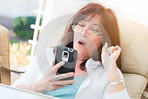 Shocked Middle Aged Woman Gasps While Using Her Smart Phone