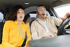 Shocked Middle Eastern couple in car having traffic accident risk