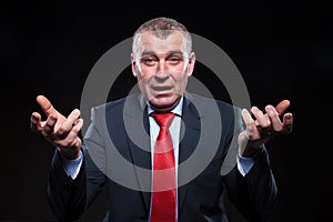 Shocked old business man gesturing in confusion