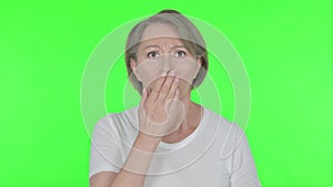 Shocked Old Woman by Loss on Green Background