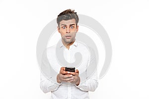 Shocked or outraged man with short dark hair chatting or typing