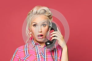 Shocked pinup woman phone on red background