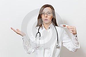 Shocked sad upset young doctor woman in medical gown with stethoscope, glasses, clinical electronic thermometer with