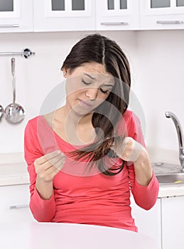 Shocked and sad woman - broken hair after coloration.