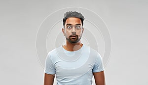 Shocked or scared man over grey background