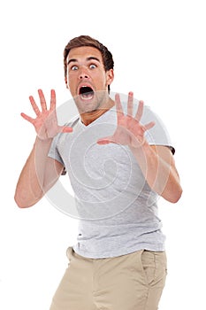 Shocked, scared and portrait of man on a white background for surprise, horror and fear reaction. Shouting, screaming