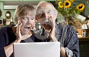 Shocked Senior Couple with a Laptop Computer