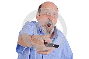 Shocked senior man watching tv with remote control