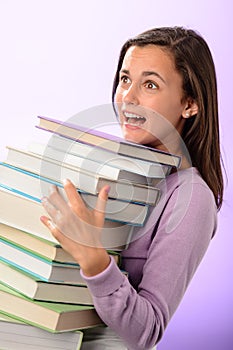 Shocked student girl carry stack of books