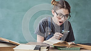 Shocked student looking through a magnifying glass