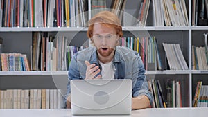 Shocked, Stunned Man with Red Hairs Working on Laptop