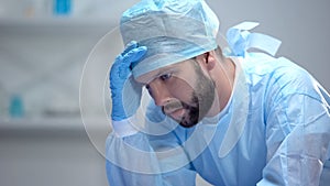 Shocked surgeon thinking about last unsuccessful operation, responsible work