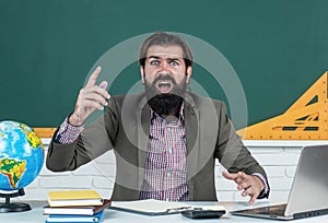 shocked and surprised bearded male teacher in university has educational problems, school study