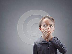 Shocked and surprised child looking into copy space