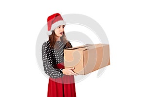 Shocked and surprised pretty young woman holding big carton gift box. isolated on white background. holidays concept