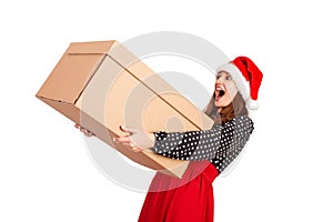 Shocked and surprised pretty young woman holding big carton gift box. isolated on white background. holidays concept