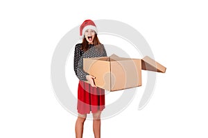 Shocked and surprised pretty young woman holding open big carton gift box. isolated on white background. holidays concept