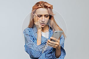 Shocked surprised woman looking at phone, receives sms, news, message, shocked, isolated