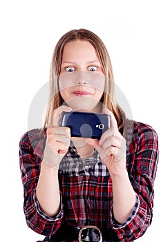 Shocked teen girl looking at mobile phone screen