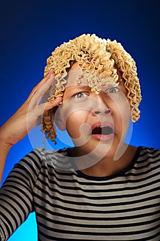 Shocked teen girl with macaroni instead hair