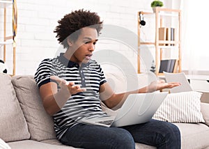 Shocked teen guy having problem in laptop