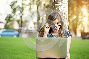 Shocked teenager looking at computer stunned